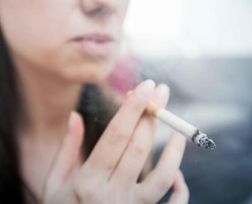 close up image of woman smoking
