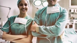 Portrait of surgeons standing while smiling