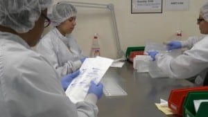 packaging sanitary Manufacturing Laboratory where Scientists in Protective Coverall's Work with Industrial High Precisio